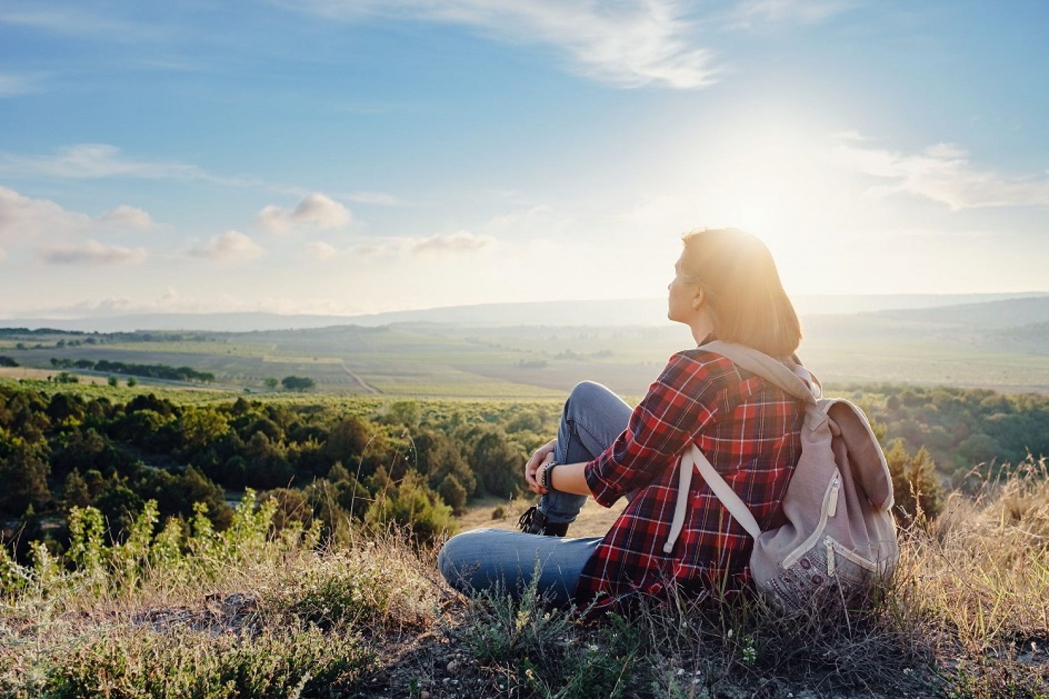 Young hipster girl enjoy sunset on viewpoint. Travel woman with backpack. Enjoying nature sunset. Relaxing in mountains at sunrise. Trekking concept