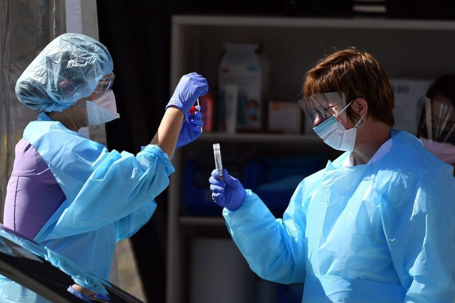 Medical workers at Kaiser Permanente French Campus test a patient for the novel coronavirus, COVID-19, at a drive-thru testing facility in San Francisco, California on March 12, 2020. - Between 70 to 150 million people in the United States could eventually be infected with the novel coronavirus, according to a projection shared with Congress, a lawmaker said March 12, 2020. (Photo by Josh Edelson / AFP) (Photo by JOSH EDELSON/AFP via Getty Images)