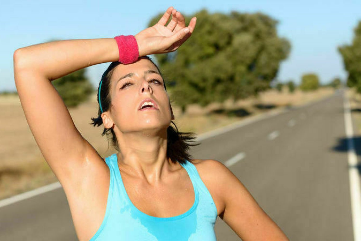 Tired woman sweating after running
