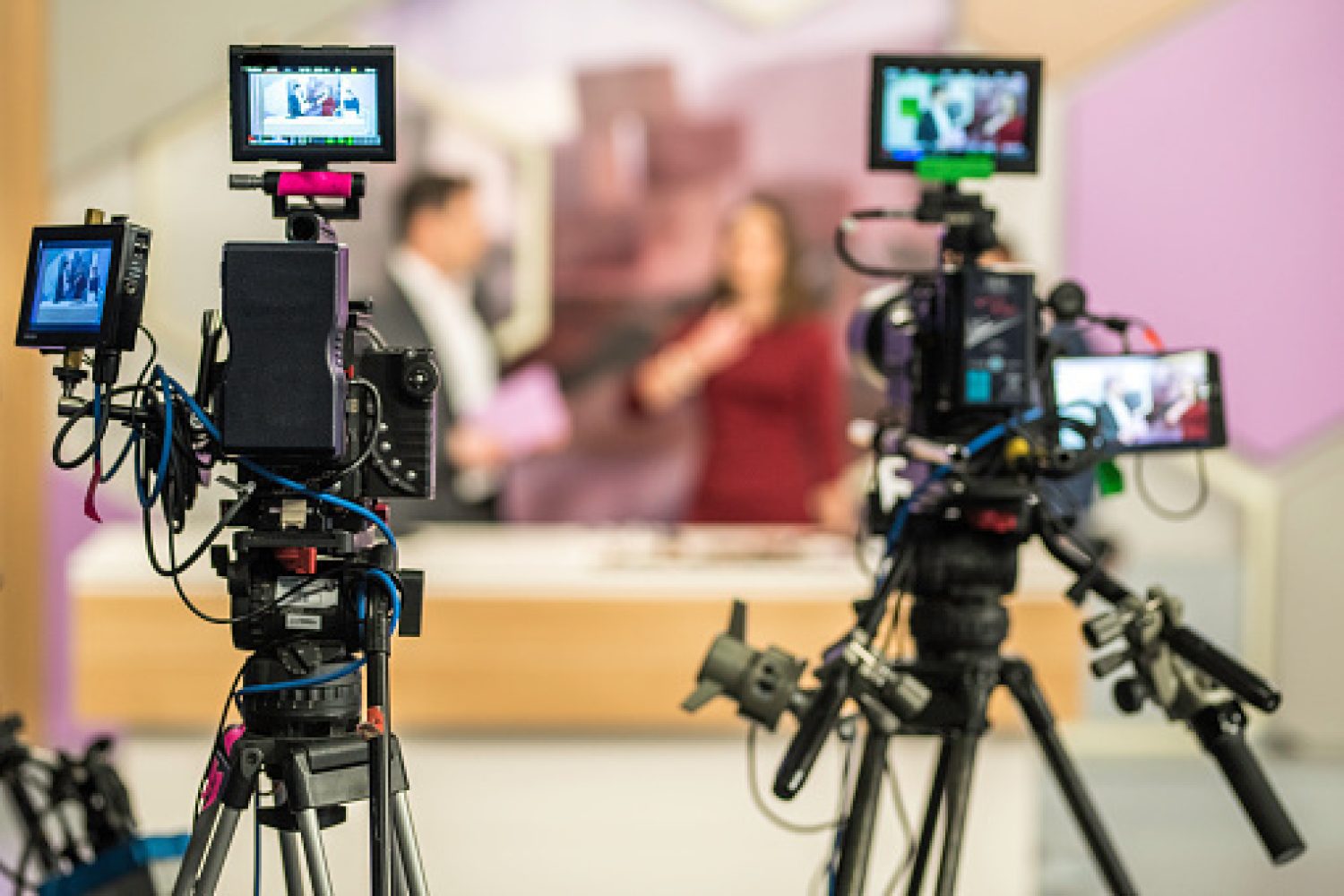 Rear view of two cameras filming an infomercial TV-show.