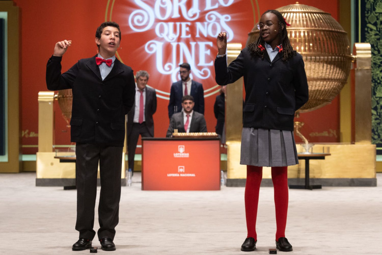 MADRID, SPAIN - DECEMBER 22: Two children from the San Ildefonso residence sing a fourth prize in the 2022 Christmas Lottery Extraordinary Draw, the number '54289', at the Teatro Real in Madrid, on 22 December, 2022 in Madrid, Spain. The draw is being held on this occasion with full capacity in the stalls of the Teatro Real and a total of 2,520 million euros at stake in prizes, which is 112 million more than last year. This year, the issue consists of 180 series, eight more than in previous years, of 100,000 numbers each. This issue amounts to 3,600 million euros, 70 percent of which are distributed in prizes. (Photo By Eduardo Parra/Europa Press via Getty Images)