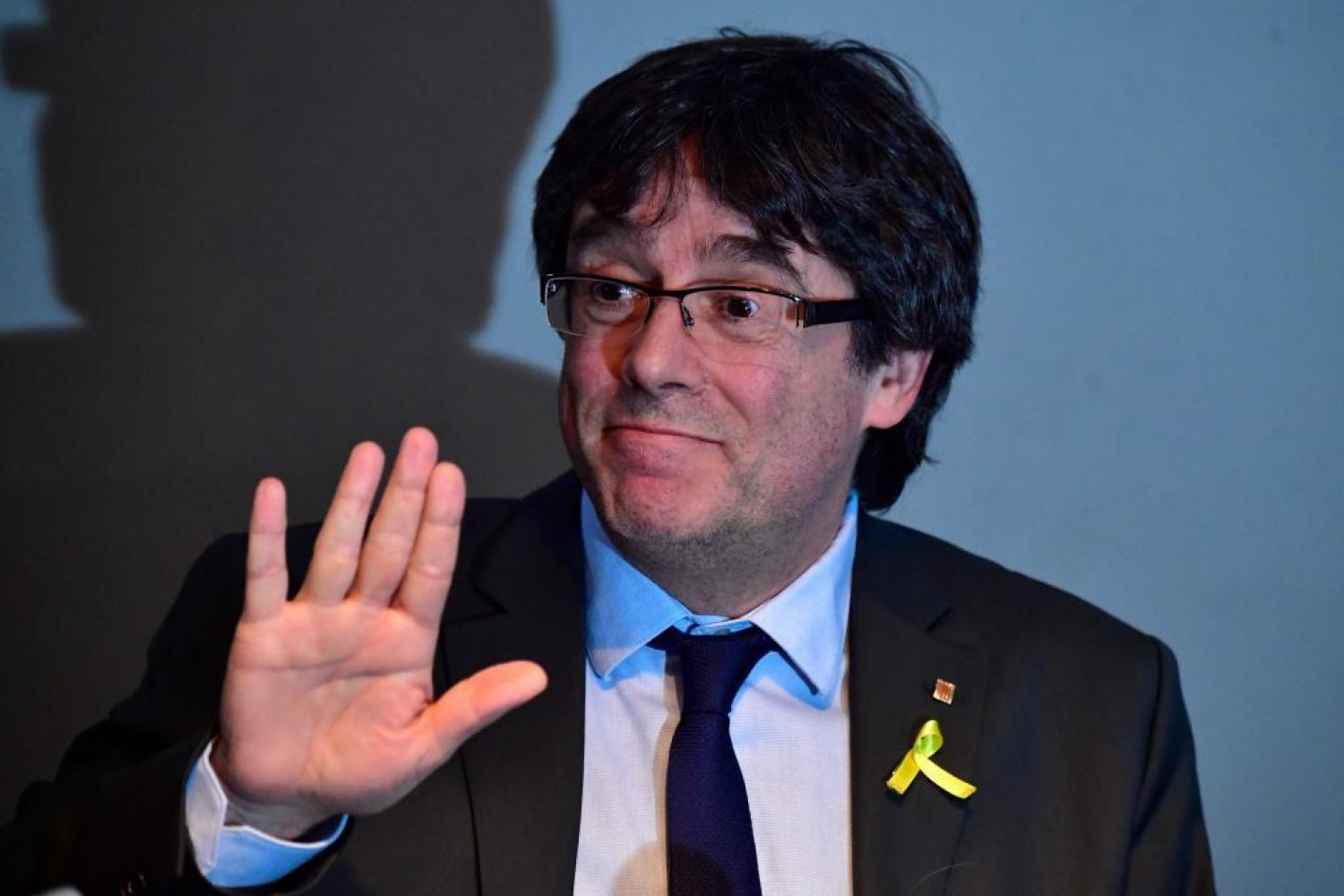 Catalonia's ousted leader Carles Puigdemont gestures during a press conference on April 7, 2018 in Berlin after judges refused his extradition to Spain on a rebellion charge and ordered him freed on bail pending a ruling on a lesser corruption charge. A German court on April 5, 2018 refused a request from Spain to extradite Puigdemont on a rebellion charge following his arrest in Germany last month, and ordered his release on bail pending a hearing on a lesser charge. / AFP PHOTO / John MACDOUGALL